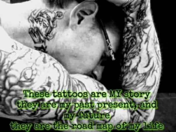 Close-up of a person with intricate tattoos, resting their head on their arms.